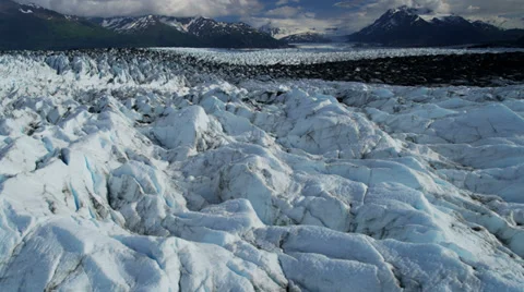 Aerial view Knik Glacier moraine crevasses feeding the Knik River, Alaska, USA Stock Footage