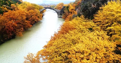 Aerial view of Konitsa stone bridge and Aoos River an autumn day, Greece. Nat Stock Footage 82804585