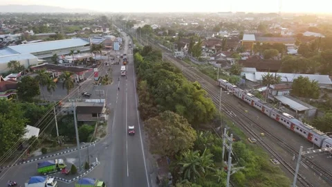 Aerial view of KRL Train in sunset near road in Indonesia Video stock 244362980