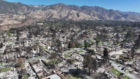 Aerial view of the L.A. fires with destroyed neighborhood homes in Altadena Stock Footage 306783655