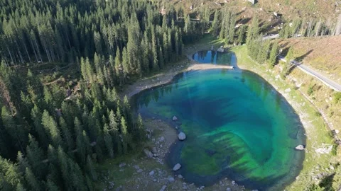Aerial view of Lago di Carezza in the Dolomite Mountains, Italy. Stock Footage 345602410
