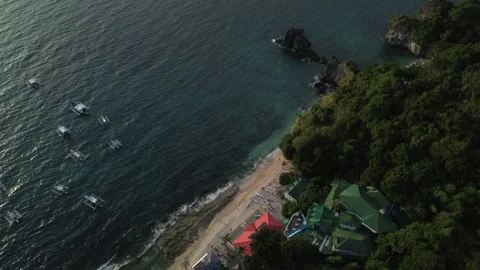 Aerial view of lagoon surrounded by lush green hills and ocean on Apo Island Stock Footage 332618965