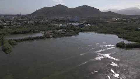 Aerial View of Lagoon Water Surface With Mountain Behind, Maristany Stock Footage 340589447