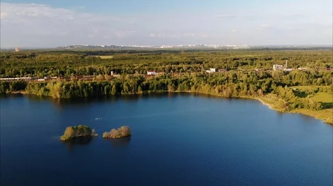 Aerial view of the lake, along which the freight train moves. Stock Footage 106926765