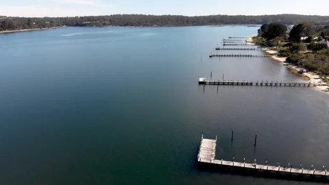 Aerial View of Lake and Small Piers and Bush Land Stock Footage 99019780