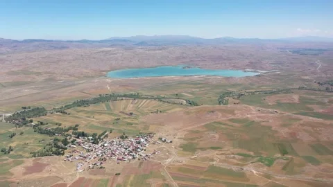 Aerial view of lake green fields and town Stock Footage 294066488