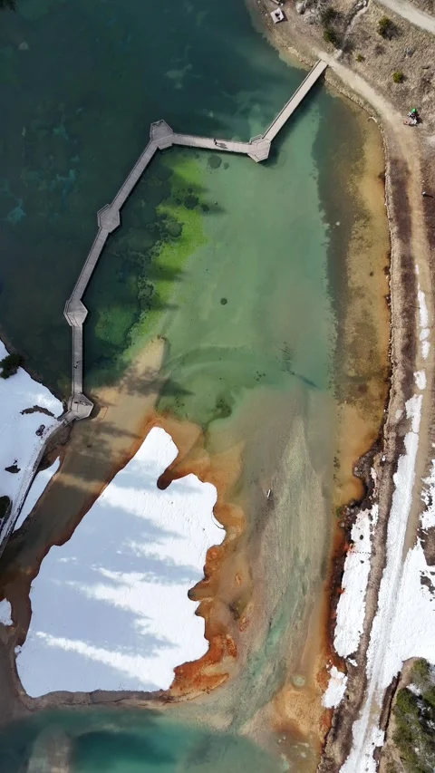 Aerial  view of lake Lac de la Rosiere by spring in Courchevel ski resort Stock Footage 334303219
