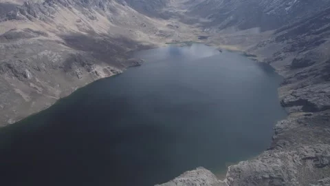 AERIAL VIEW OF A LAKE IN THE MOUNTAIN Stock Footage 326228772