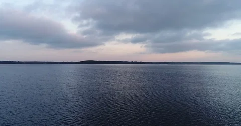 Aerial view of lake with reflection late in the evening 動画素材 84048868