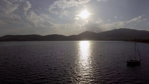 Aerial view of lake Sevan in Armenia, boat, backlight and beautiful mountains Stock Footage 69900693