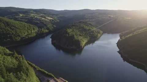 Aerial View of Lake Splitting Mountain with Pine Forests at Sunset in Alps Stock Footage 315618663