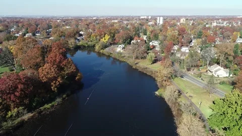 Aerial View of Lake Surrounded by Fall Colors Video stock 145703500
