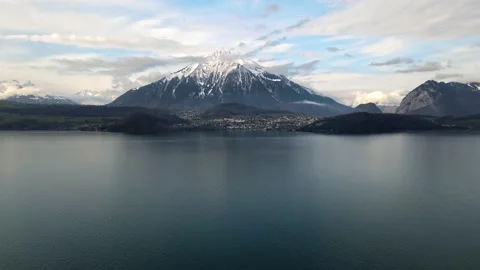 Aerial view of Lake Thun with a view of the Niesen mountain and the city Spiez Stock Footage 154487174