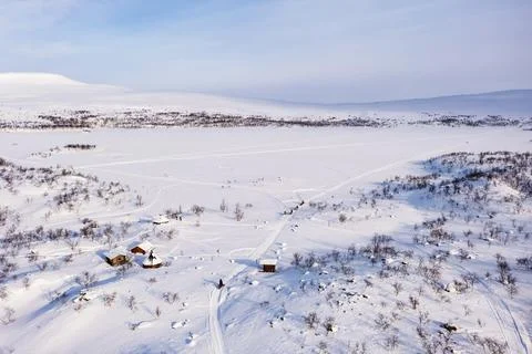 Aerial view of lake Tshahkajarvi, sunny day, in Lapland - rising, drone shot Stock Photos