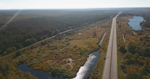 Aerial view of lakes, fields, forests and highway Stock Footage 345370633