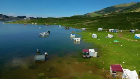 Aerial View of Lakeside Cabins and Water Stock Footage 337100925