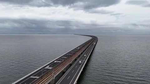 Aerial view of lakeside highway through green wetland and water in China Stock Footage 337600944