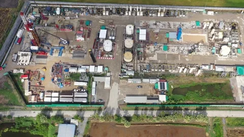 Aerial View of Land Drilling Rig and Oilfield Facility in Rice Fields Stock Footage 336583221