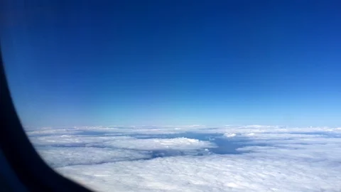 Aerial view landscape, clouds and sky as seen through window of an airplane. 4K Stock-Footage 105097935