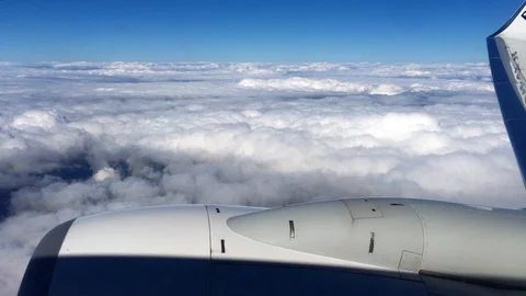 Aerial view landscape, clouds and sky as seen through window of an airplane. 4K Stock Footage 105098181