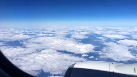 Aerial view landscape, clouds and sky as seen through window of an airplane. 4K 스톡 동영상 105098305
