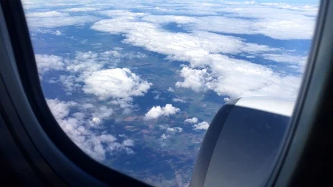 Aerial view landscape, clouds and sky as seen through window of an airplane. 4K 스톡 동영상 105098344