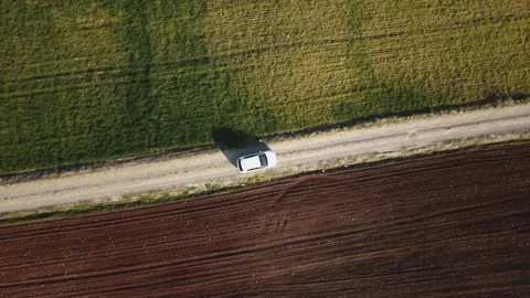 An aerial view of a landscape with distinct sections of green and brown fields Stock Footage 258644006
