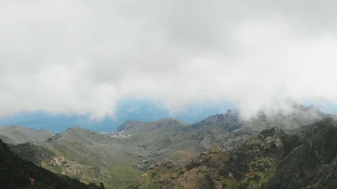 Aerial view - landscape with fast clouds flying low over a beautiful green Видео 111309123