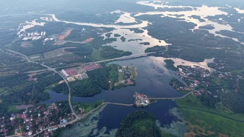 Aerial view of landscape with river, bridge, small houses, and green forest Vídeos de archivo 344822473