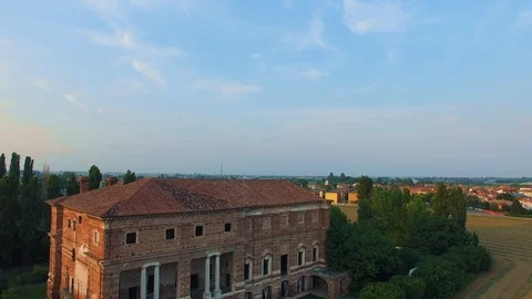 Aerial view of a large ancient red brick house in the Italian countryside. Stock Footage 92199397