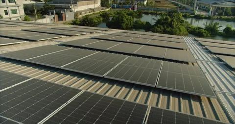 Aerial view of a large Array of solar panels installed on the industrial buildin Stock Footage 262086177