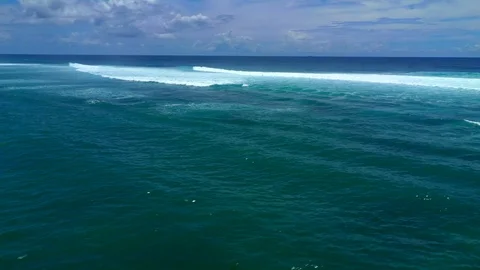 Aerial view of large blue ocean waves crashing on sunny day. Bali, Indonesia. Stock Footage 126987781
