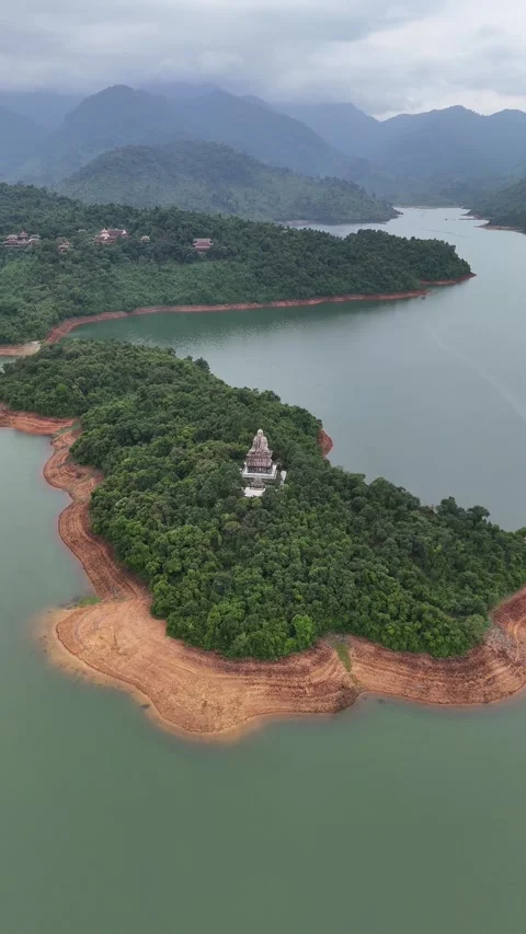 Aerial View of a Large Buddha Statue on a Forested Island in Hue, Vietnam Stock-Footage 335835652