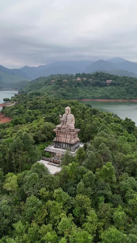 Aerial View of Large Buddha Statue on Lush Green Peninsula in Hue, Vietnam Video stock 335837649