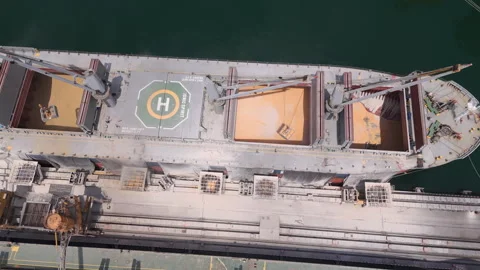 Aerial view of a large bulk carrier ship loaded with cereal grain at a Stock Footage 345904780