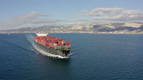 Aerial view of large cargo ship with red containers floating on sea waves Stock Footage 145783782
