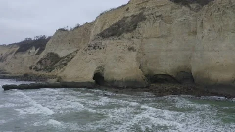 Aerial view of the large cliffs seperating the mainland from the pacific ocean Stock Footage 146754564