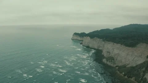 Aerial view of large cliffs seperating the ocean from the mainland Stock Footage 146754604
