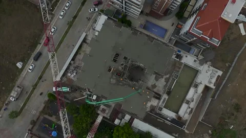 Aerial View: A large construction site shows workers pouring concrete and Stock Footage 296074376
