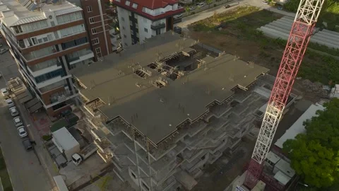 Aerial View: A large construction site with workers and machines actively Stock Footage 296076547