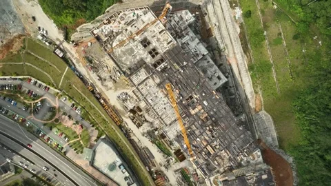 Aerial View of Large Construction Site with Heavy Machinery and Workers Busy at Stock Footage 316450439