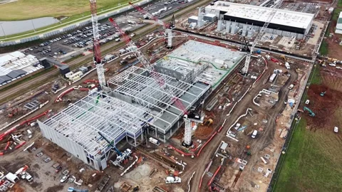 Aerial view of a large construction site with cranes and steel framework 스톡 동영상 340503633