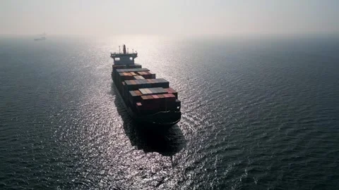 Aerial view of a large container ship in the open sea at sunset Stockbeeldmateriaal 333554386