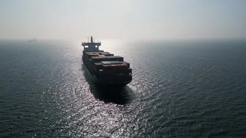 Aerial view of a large container ship in the open sea at sunset Stock Footage 333554397