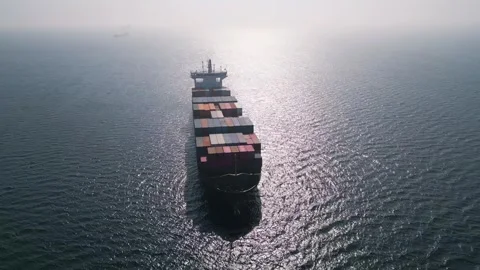 Aerial view of a large container ship in the open sea at sunset Stock Footage 333554406
