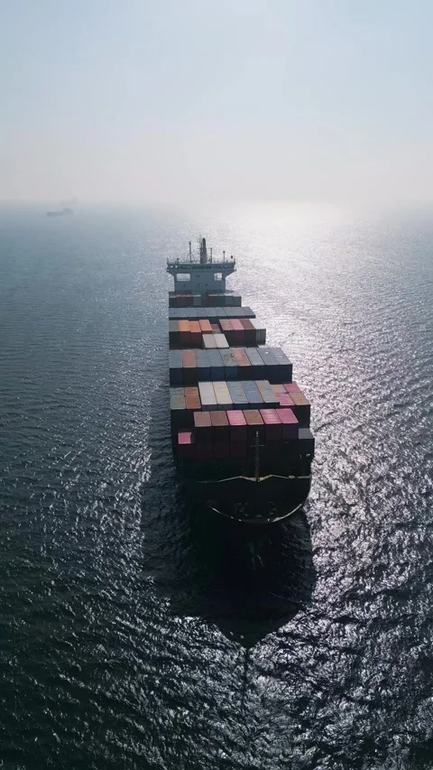 Aerial view of a large container ship in the open sea at sunset Stock Footage 333554455