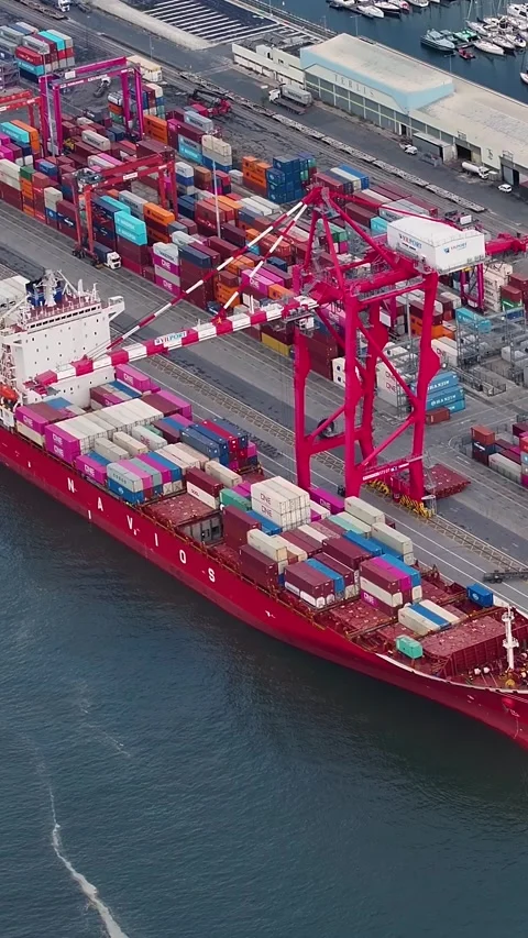 Aerial view of a large container ship unloading at an industrial port 스톡 동영상 340581623