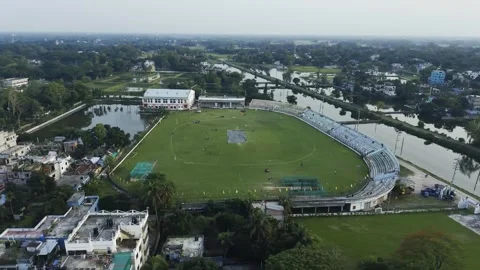 Aerial view of a large cricket stadium with green field and curved stands b.. Stock Footage 338302379