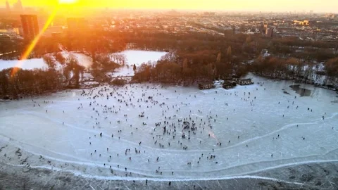 Aerial view of a large crowd of people ice skating near the Flevopark on a Stock Footage 148374041