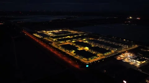 Aerial view of a large data center at night with cooling towers Stock Footage 341073661